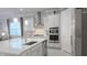 Stylish kitchen featuring white cabinets, stainless steel appliances, and modern lighting at 2853 Willowseed Ln, St Cloud, FL 34772