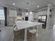 Open-concept kitchen with a quartz island, stainless steel appliances, and modern white cabinetry at 2853 Willowseed Ln, St Cloud, FL 34772
