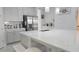Bright kitchen with a large island with seating, stainless steel appliances, and pendant lighting for a modern feel at 2853 Willowseed Ln, St Cloud, FL 34772