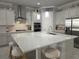 Bright kitchen featuring a large island, stainless steel appliances, and modern pendant lighting at 2853 Willowseed Ln, St Cloud, FL 34772