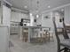 Bright kitchen featuring a large island with seating and stainless-steel refrigerator at 2853 Willowseed Ln, St Cloud, FL 34772
