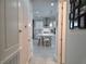 View from hall to the bright, modern kitchen with a large center island and bar stool seating at 2853 Willowseed Ln, St Cloud, FL 34772
