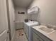 Well-organized laundry room with modern appliances, ample storage, utility sink, and stylish decor at 2853 Willowseed Ln, St Cloud, FL 34772