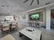 Open concept living room featuring a decorative accent wall and view of the kitchen at 2853 Willowseed Ln, St Cloud, FL 34772