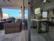View of the covered patio featuring wicker furniture, ceiling fan, and tile flooring leading to interior living area at 2853 Willowseed Ln, St Cloud, FL 34772