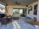 Covered patio featuring comfortable seating, a ceiling fan, an outdoor TV, and sliding glass doors at 2853 Willowseed Ln, St Cloud, FL 34772