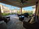 Expansive screened-in patio with ample seating, dining area, grill, and ceiling fan for outdoor entertaining at 2853 Willowseed Ln, St Cloud, FL 34772