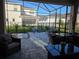 Covered patio featuring comfortable seating, a ceiling fan, and a view of the backyard at 2853 Willowseed Ln, St Cloud, FL 34772