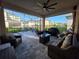 Expansive screened-in patio with ample seating, dining area, grill, and ceiling fan for outdoor entertaining at 2853 Willowseed Ln, St Cloud, FL 34772