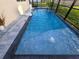 Full view of the refreshing swimming pool with basketball hoop, patio, and screened enclosure at 2853 Willowseed Ln, St Cloud, FL 34772