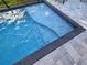 Close-up of the pristine pool featuring a sleek design, steps, and refreshing blue water at 2853 Willowseed Ln, St Cloud, FL 34772