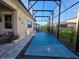 Full view of the refreshing swimming pool with basketball hoop, patio, and screened enclosure at 2853 Willowseed Ln, St Cloud, FL 34772
