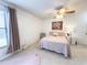Bright bedroom featuring a large window, tile flooring and ceiling fan at 3006 S Semoran Blvd # H-3, Orlando, FL 32822