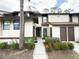 Inviting townhome showcases lush landscaping and a well-lit walkway at 3006 S Semoran Blvd # H-3, Orlando, FL 32822