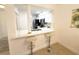 Open kitchen with white cabinets, a breakfast bar, and views into the living area at 3006 S Semoran Blvd # H-3, Orlando, FL 32822