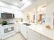 Bright, white kitchen with modern appliances, a breakfast bar, and open layout at 3006 S Semoran Blvd # H-3, Orlando, FL 32822