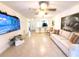 Open-concept living room with tile floors, comfortable seating, and access to kitchen bar at 3006 S Semoran Blvd # H-3, Orlando, FL 32822