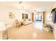 Spacious living room with tile floors, neutral decor, and access to patio and kitchen at 3006 S Semoran Blvd # H-3, Orlando, FL 32822