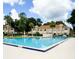 Beautiful swimming pool with ample seating and community buildings in the background at 3006 S Semoran Blvd # H-3, Orlando, FL 32822