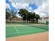 Outdoor tennis court with a view of the community buildings and lush greenery at 3006 S Semoran Blvd # H-3, Orlando, FL 32822