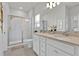 Clean, bright bathroom with double vanity, tile flooring, and glass-enclosed shower at 3026 Prospect Trl, St Cloud, FL 34771
