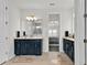 Bright bathroom with dual vanities, stylish fixtures, and a doorway leading to the bedroom at 3026 Prospect Trl, St Cloud, FL 34771