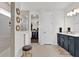 Modern primary bathroom featuring a glass shower, walk-in closet, and dark vanity with gold fixtures at 3026 Prospect Trl, St Cloud, FL 34771