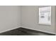 Empty bedroom featuring hard wood floors, white walls, and a window with blinds at 3026 Prospect Trl, St Cloud, FL 34771