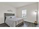 Comfortable bedroom featuring a grey bed frame, decorative pillows, and hardwood floors at 3026 Prospect Trl, St Cloud, FL 34771