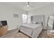 Well-lit bedroom with a plush bed, ceiling fan, and minimalist decor at 3026 Prospect Trl, St Cloud, FL 34771
