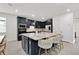 Modern kitchen featuring an island with seating, stylish fixtures and ample counter space at 3026 Prospect Trl, St Cloud, FL 34771