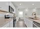 Modern kitchen with white cabinets, stainless steel appliances, and a quartz countertop island at 3026 Prospect Trl, St Cloud, FL 34771