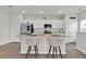 Stylish kitchen with white cabinets, a kitchen island with seating, and modern appliances at 3026 Prospect Trl, St Cloud, FL 34771