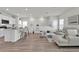 Open-concept living area with kitchen island, seating, and a comfortable sofa at 3026 Prospect Trl, St Cloud, FL 34771