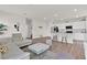 Open-concept living space with a kitchen island and a modern sofa at 3026 Prospect Trl, St Cloud, FL 34771