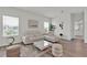 Bright living room with modern decor, neutral tones, and wood-look flooring at 3026 Prospect Trl, St Cloud, FL 34771