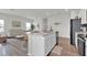 Open-concept living space with a modern kitchen island, sleek appliances, and comfortable seating at 3026 Prospect Trl, St Cloud, FL 34771