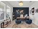 Stylish home office featuring a modern desk, dark accent wall and natural lighting at 3026 Prospect Trl, St Cloud, FL 34771