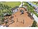 Aerial view of a community playground with swings and a covered picnic area at 3026 Prospect Trl, St Cloud, FL 34771
