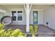 Inviting front porch with decorative seat, pillar, and door to welcome you home at 3026 Prospect Trl, St Cloud, FL 34771