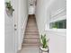 Inviting staircase with wood steps, white railings, and a window providing natural light at 3026 Prospect Trl, St Cloud, FL 34771