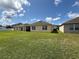 Expansive backyard with lush green lawn, offering ample space for outdoor activities and relaxation at 306 Briar Patch Loop, Davenport, FL 33896