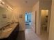 Neutral bathroom featuring tiled floor, access to toilet, shower and Primary bedroom at 306 Briar Patch Loop, Davenport, FL 33896