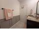 Bathroom features wainscotting, granite countertop and neutral colors at 306 Briar Patch Loop, Davenport, FL 33896