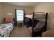 Comfortable bedroom showcasing a twin bed, bunk bed, and a window, illuminated with a 'Hustle' neon sign for inspiration at 306 Briar Patch Loop, Davenport, FL 33896