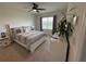 Spacious bedroom with a ceiling fan, large window, and neutral-colored walls and carpet at 306 Briar Patch Loop, Davenport, FL 33896
