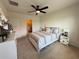 Bright bedroom featuring a ceiling fan, neutral color palette, and convenient access to the Primary bath at 306 Briar Patch Loop, Davenport, FL 33896