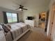 Cozy bedroom featuring ample natural light, neutral tones, and seamless access to living areas at 306 Briar Patch Loop, Davenport, FL 33896