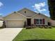 Charming single-Gathering home featuring a well-manicured lawn and tasteful landscaping at 306 Briar Patch Loop, Davenport, FL 33896