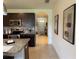 Hallway view to the kitchen featuring modern backsplash and stainless appliances at 306 Briar Patch Loop, Davenport, FL 33896